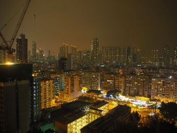 Illuminated cityscape against sky at night