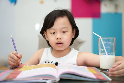 Portrait of boy holding book