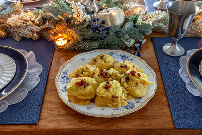 Mashed potatoes with bacon, chaddar, cheese, sour cream and chives on a holiday table at christmas.