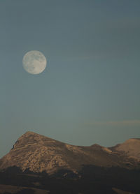 Low angle view of moon against clear sky at night