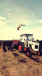 Tractor on field against sky