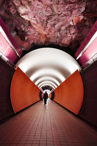 Walking in empty subway along the walls