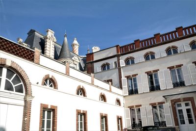 Low angle view of buildings against sky in city