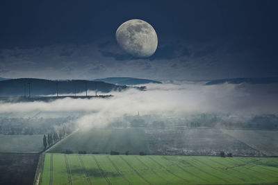 Scenic view of land against sky at night