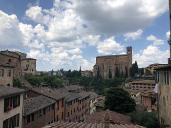 Buildings in town against sky