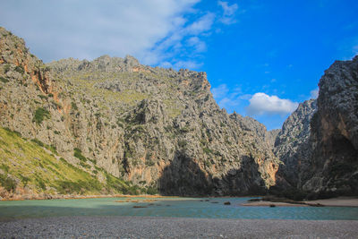 Scenic view of sea and mountains against sky