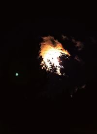 Low angle view of bonfire against dark sky