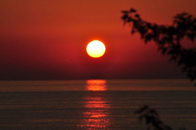 Scenic view of sea against orange sky