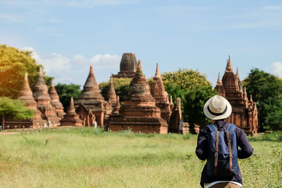 Rear view of man visiting old historic temple