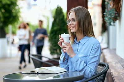 Young woman using mobile phone in park