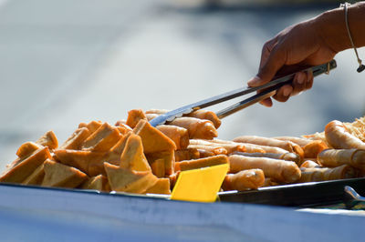 Close-up of hand preparing food at store