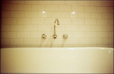 Close-up of illuminated lamp against wall