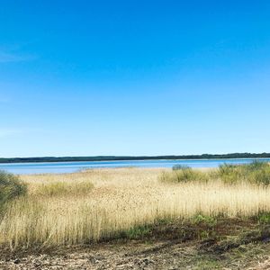 Scenic view of sea against clear blue sky