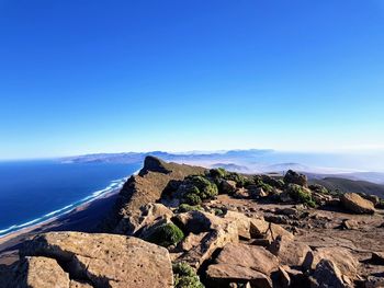 Scenic view of sea against clear blue sky