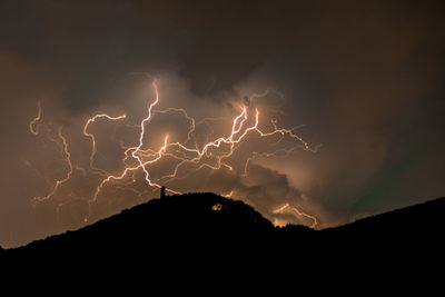 Low angle view of lightning against sky at night