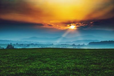 Scenic view of field against sky during sunset
