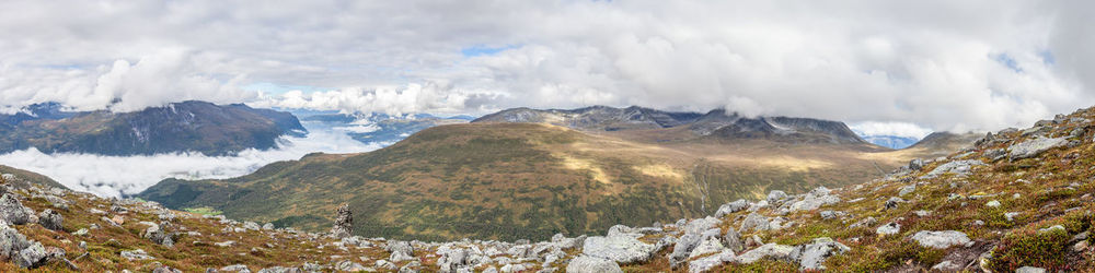 Scenic view of mountains against cloudy sky