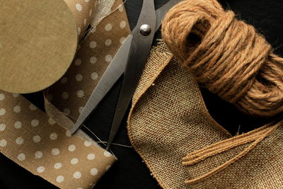 Close up of scissor with burlap and ropes on table