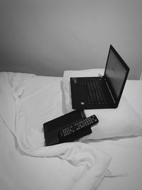 Close-up of mobile phone on bed