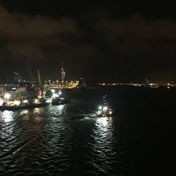 Boats in sea at night