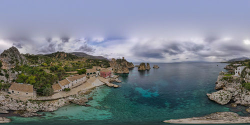 Panoramic view of sea and mountains against sky