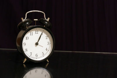 Close-up of clock on table