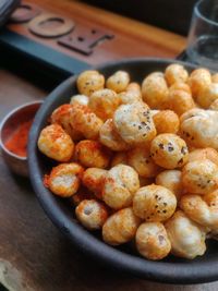 Close-up of popped lotus seeds  in a bowl with peri peri powder 