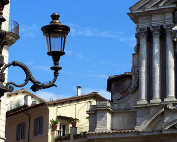 Low angle view of street light against building