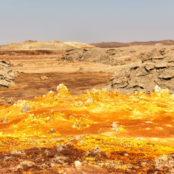 Scenic view of desert land against sky