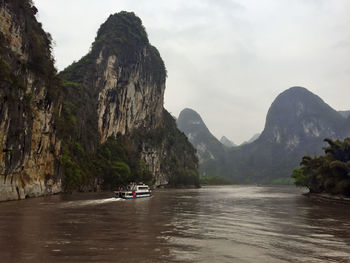 Scenic view of river with mountains in background