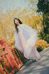 Woman standing in park during autumn