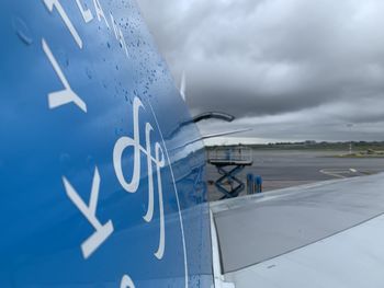 Close-up of airplane sign against sky