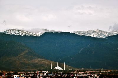 Scenic view of mountains by shah faisal masjid against sky