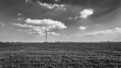 Scenic view of field against cloudy sky