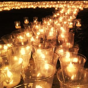 Lit tea light candles at night