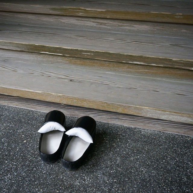 shoe, high angle view, still life, close-up, single object, shadow, street, footwear, no people, ball, pair, outdoors, two objects, sunlight, flooring, day, absence, floor, empty, sport