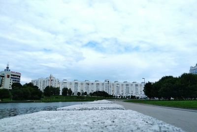 Buildings in city against cloudy sky