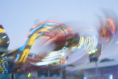 Illuminated ferris wheel against sky at night