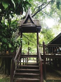 Gazebo in park by building in forest