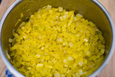 High angle view of yellow soup in bowl on table