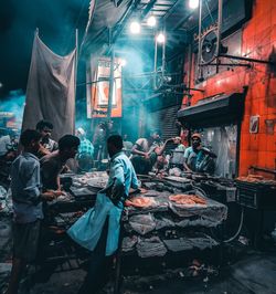 Group of people working at market