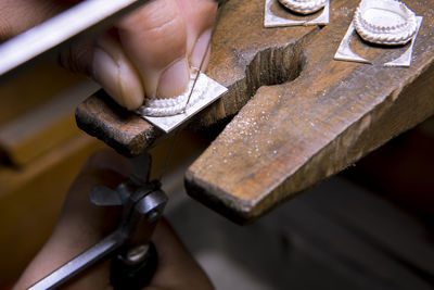 Close-up of man working on metal