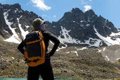 Rear view of man standing on mountain