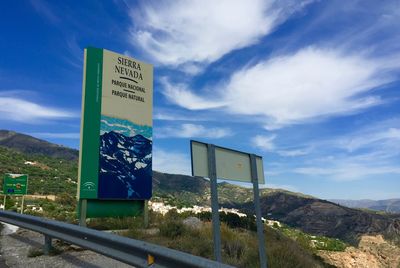 Information sign on landscape against cloudy sky