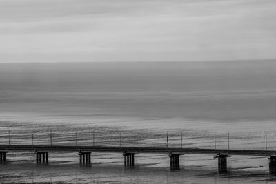 Scenic view of bridge with sea against sky 