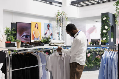 Rear view of man standing in store