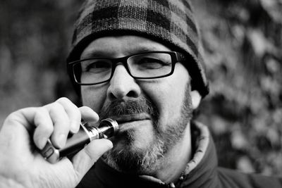 Close-up of man holding electronic cigarette