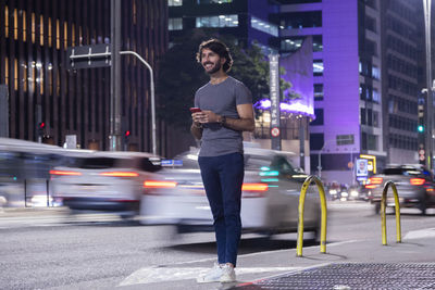 Portrait of young man standing on street