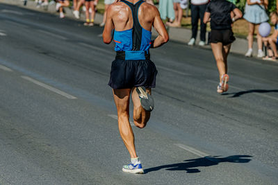 Rear view of woman walking on road