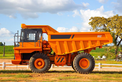 Low angle view of tractor on field against sky